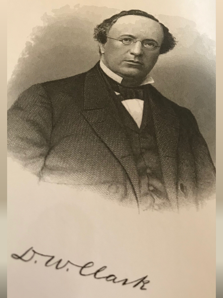 Bishop DW Clark Website A man in a suit and tie standing.
