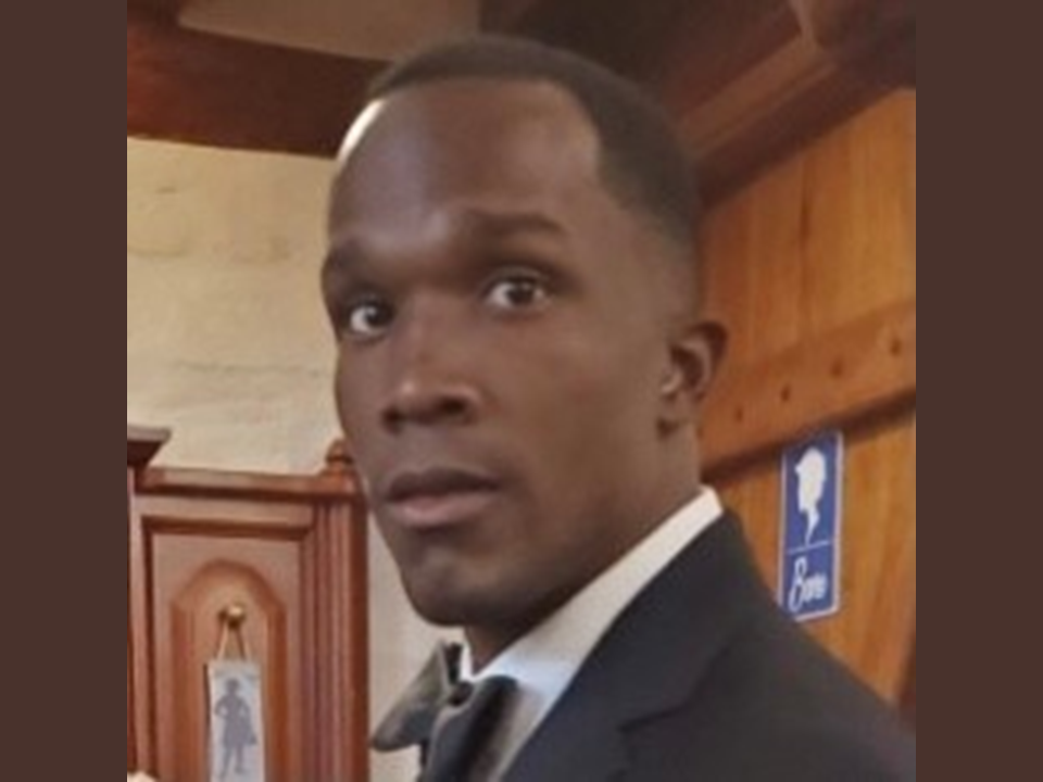 A man in a suit and tie standing up.