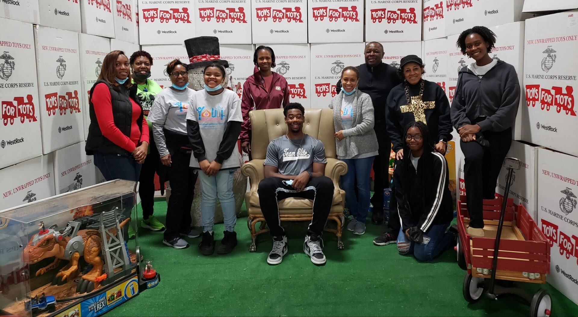 A group of people standing around in chairs.