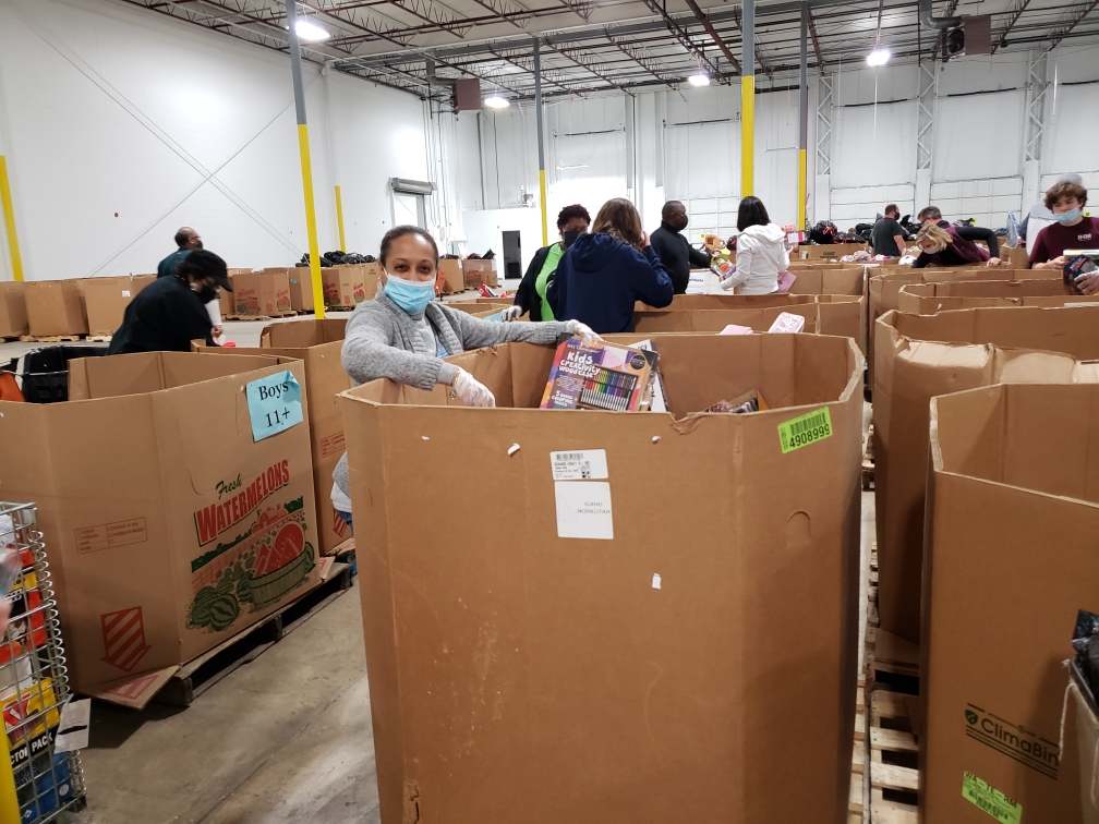 A warehouse filled with boxes of food and people.