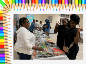 A group of people standing around a table with many books.